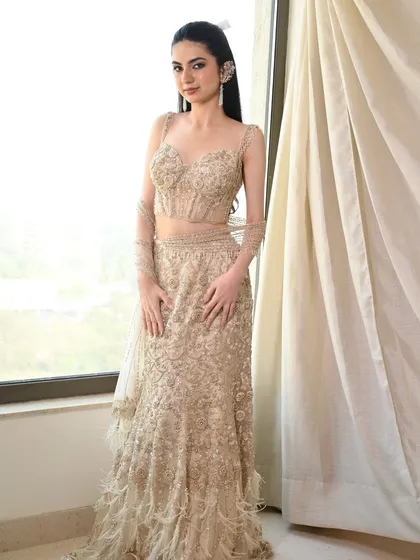 The full look from our editorial shoot. The sleek hair and makeup are the perfect pairing for this stunning, feathered, and embellished gown.