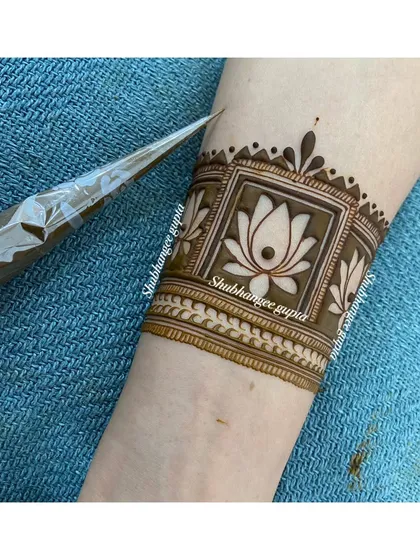 A simple and clean arm band design with a single lotus in the center. This is a great example of how a traditional motif can be used in a minimalist way.