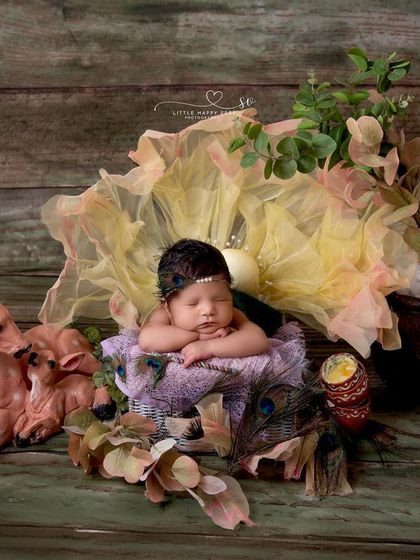 A sweet Janmashtami scene with our little one surrounded by deer figurines and peacock feathers. I love creating a full, story-like environment for my themed photoshoots.