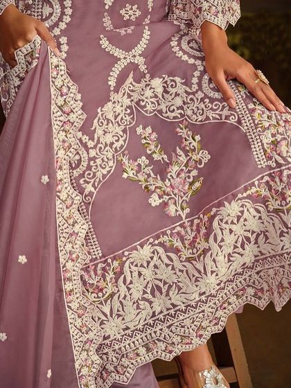 This mauve organza Anarkali is soft and dreamy. The detailed thread embroidery on the hem and sleeves gives it a delicate, handcrafted feel.