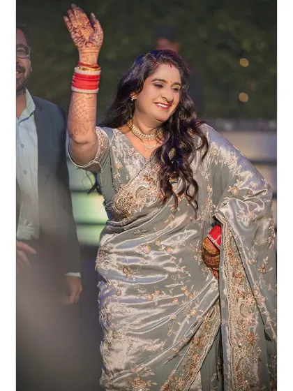 A candid moment of pure joy on the dance floor. Her hands in the air, a big smile on her face, this is what celebration looks like.