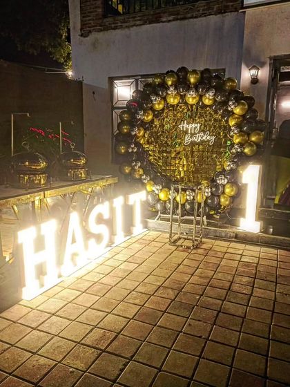 Another view of the outdoor first birthday setup, showing the catering station next to the decorations.
