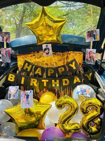 Another view of the photo-filled car boot, showing the large star-shaped foil balloons.