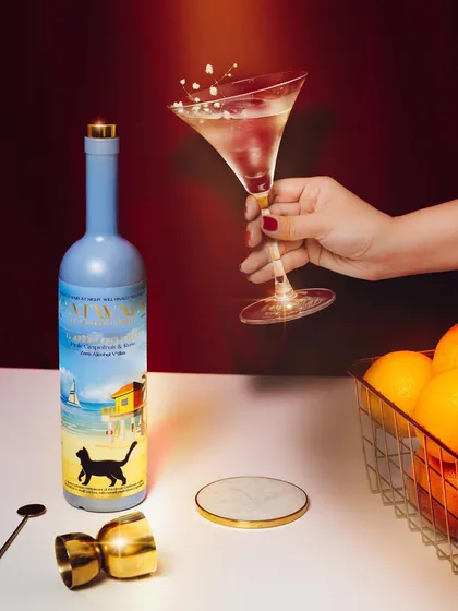 This shot uses a dramatic splash to add energy and excitement to a classic martini glass. The warm, colored lighting and fresh oranges create a vibrant and appealing composition that feels both fun and elegant.