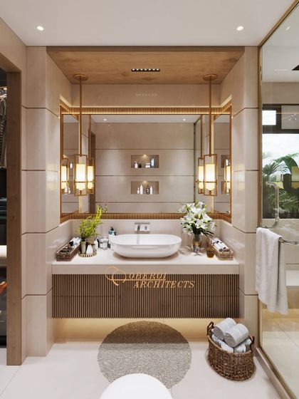 This bathroom design blends modern luxury with timeless sophistication. The warm wooden tones of the vanity contrast beautifully with the light-colored tiles and brushed gold finishes.