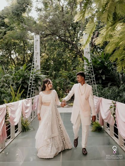 The engaged couple walking hand-in-hand across a picturesque bridge, a perfect shot from their engagement day.