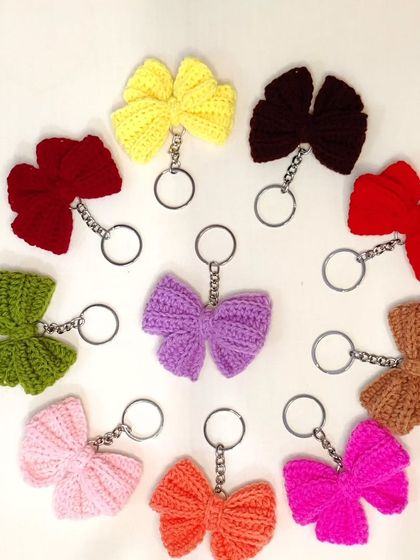 Coquette bow keychains available in a whole spectrum of colors, from bold reds and pinks to earthy tones.