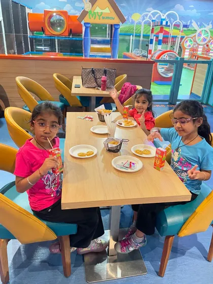 A candid moment of friends enjoying snacks and juice at our cafe.