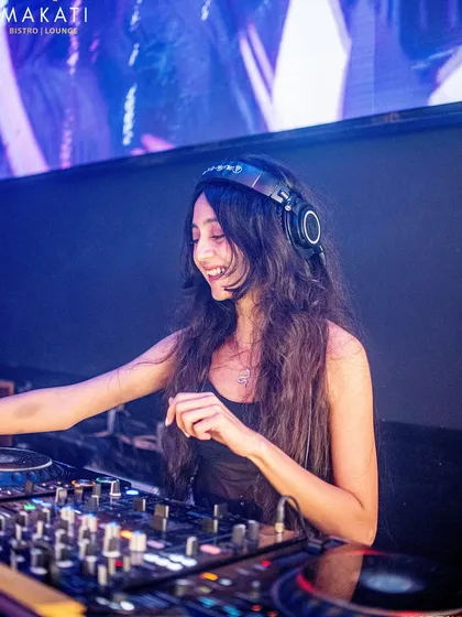 A candid shot from my set at Makati Bistro Lounge. I'm always smiling behind the decks because I genuinely love what I do, and seeing people enjoy the music is the best feeling.