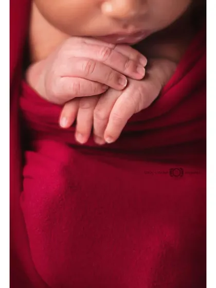 It's all about the tiny details. This close-up shot focuses on a newborn's delicate hands, a precious memory of just how small they once were.
