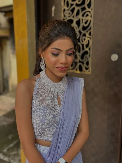 A beautiful soft glam look with a hint of pink on the eyes. The client's intricate high-neck blouse is the star, so the makeup is kept elegant and complementary.