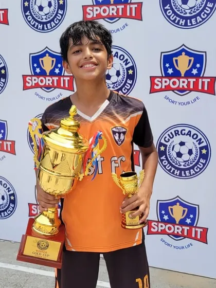 One of our U13 champions proudly holding the main trophy and his individual award.