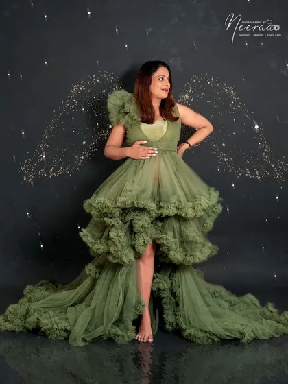 This olive green tiered tulle gown is a true showstopper. The layers of fabric create incredible texture and volume, perfect for creating dramatic, fairy-tale portraits.