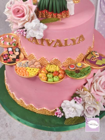 A close-up of my first-ever half-saree function cake. The platters are filled with miniature edible versions of traditional offerings, from sweets and fruits to cosmetic items.