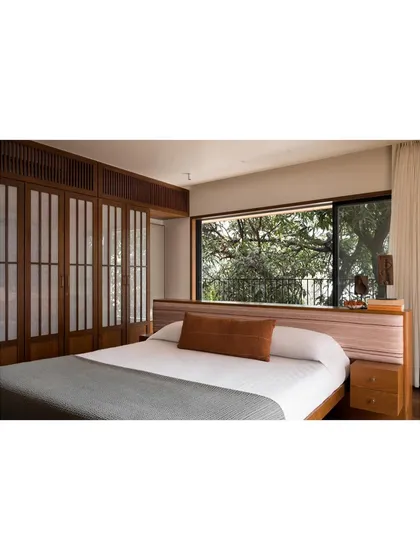 For this master bedroom, I designed a low-profile island bed with an integrated headboard and side tables. The goal was to maintain an uncluttered, zen-like space that feels open and connected to the view, making the room a true sanctuary for rest.