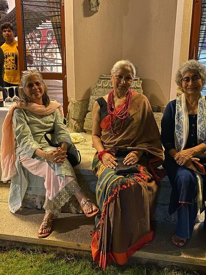 A moment of conversation between senior women artists at the dinner.