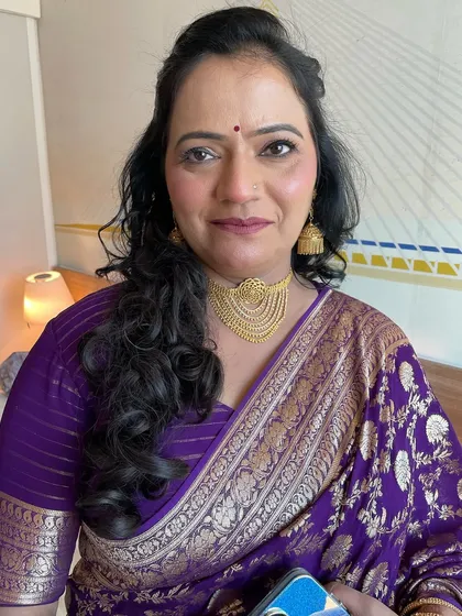 An unfiltered photo showing the final makeup look on mature skin. The skin looks hydrated, smooth, and radiant.