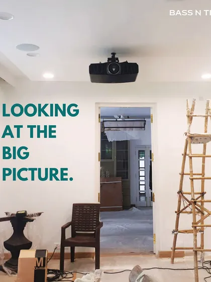 A work-in-progress shot of a home theatre installation. We focus on the big picture, ensuring the projector, screen, and in-ceiling speakers are perfectly placed for the ultimate viewing experience.