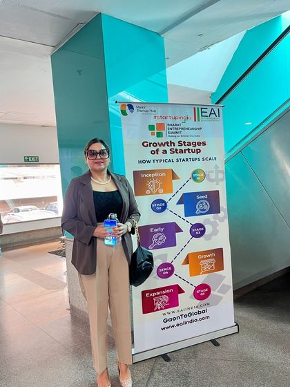 Posing next to a banner outlining the growth stages of a startup. Just like a business, our health requires a structured plan for growth and sustainability, a core theme in my corporate talks.