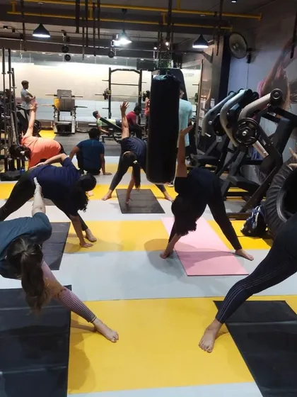 To balance the high-energy workouts, we offer yoga classes focused on flexibility, strength, and mindfulness. Here, our members are in a group yoga session, working on their form and finding their focus together.