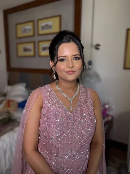 A soft and elegant updo for the sister of the bride. The gentle twists and volume at the crown create a flattering shape that is perfect for wedding festivities.