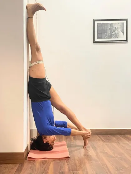 This is a variation of Sirsasana with the legs in Baddha Konasana (Bound Angle Pose). This adds a hip-opening element to the inversion and challenges the practitioner's balance and core stability in a new way.