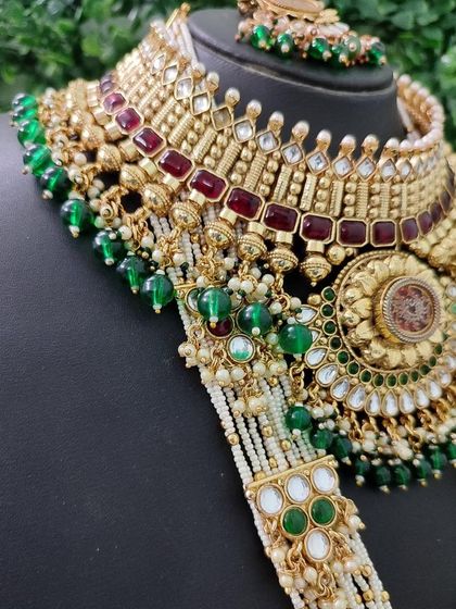 A close-up of the multi-strand pearl and beaded chains connecting the choker and rani haar, highlighting the rich texture and craftsmanship.