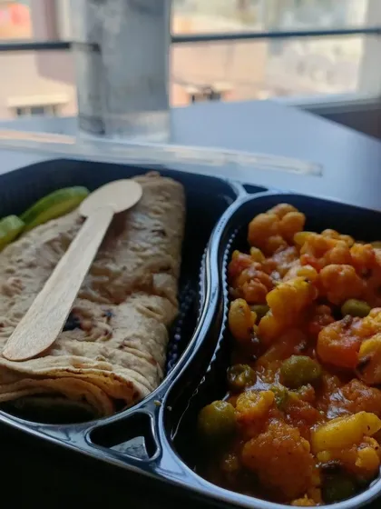 My simple roti-sabzi box is perfect for a quick and easy lunch. It comes with aloo gobi matar, soft rotis, and a side of cucumber, packed with a disposable wooden spoon.