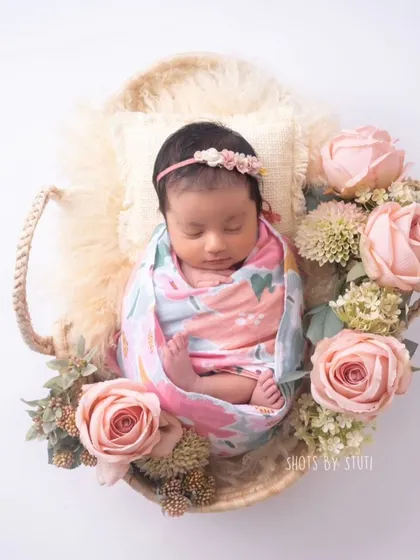 A classic newborn setup with a floral wrap and basket. This is a timeless look that parents love.