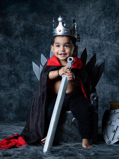 A royal portrait of our little king, complete with a crown, cape, and sword. He looks ready to defend his kingdom.