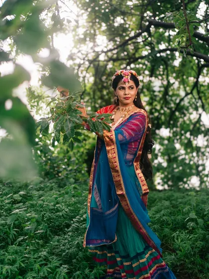A candid-style shot from the Radha series, where she interacts with the forest foliage, creating a connection between the divine and nature.