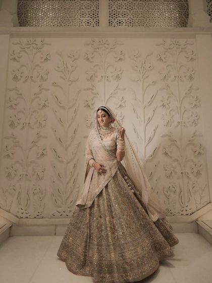 A full-length portrait of Tanisha against a beautifully detailed wall. Her entire look is a masterpiece of pastel elegance.