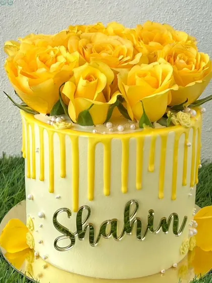 A beautiful yellow rose drip cake, featured as part of our brand story.