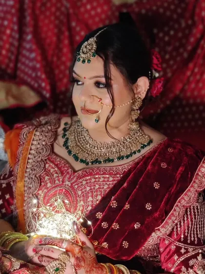 The play of light and shadows highlights the glowing skin and detailed jewellery.