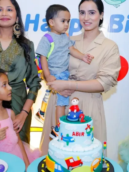 A large family gathers around the birthday cakes for a memorable photo. We can accommodate celebrations of all sizes.
