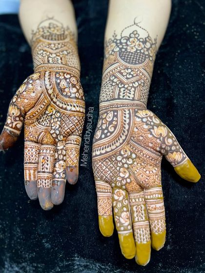 This design is a beautiful example of Indo-Arabic mehendi, with bold floral outlines filled with delicate, intricate patterns. It's a modern choice for any celebration.