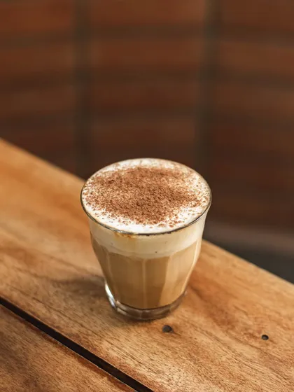 A coffee drink dusted with cocoa powder, a simple and delicious treat.