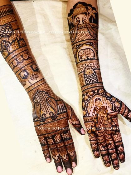 A full bridal story featuring a beautiful portrait of the bride in her ghunghat (veil) on one palm. The other hand and arms are filled with traditional motifs like elephants, swans, and a wedding palanquin.