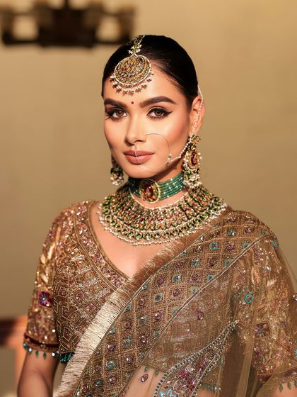 A close-up of a traditional bridal look. The focus is on timeless elegance with flawless skin and a radiant glow that lasts from pheras to vidai.