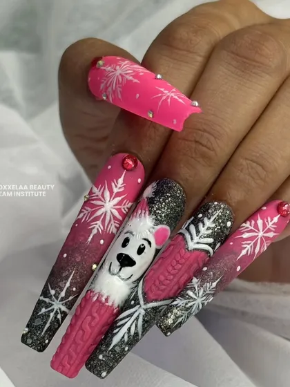The winter polar bear set on a client's hand, showing how these extra-long, imaginative nails look when worn.
