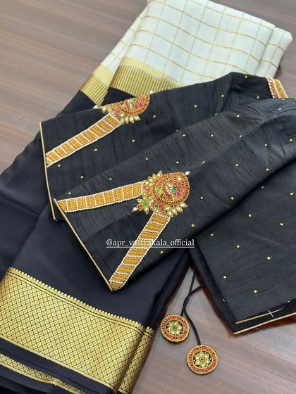 A black blouse with armlet-style embroidery on the sleeves, perfect for pairing with a Kanjivaram saree.