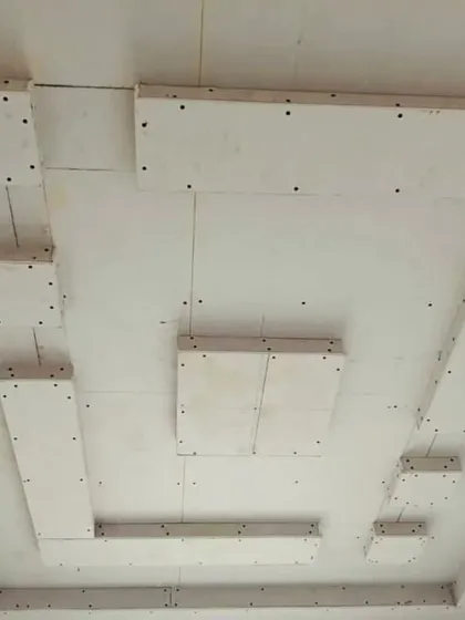A look at a ceiling design with floating panels before the finishing stage. The visible screws and joints are all covered and smoothed for a flawless final look.