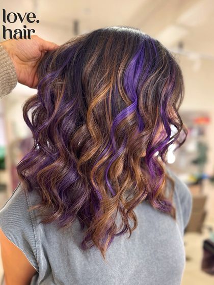A close-up shot of the brown and purple balayage, showing the detail of the colour placement and the healthy shine of the hair.
