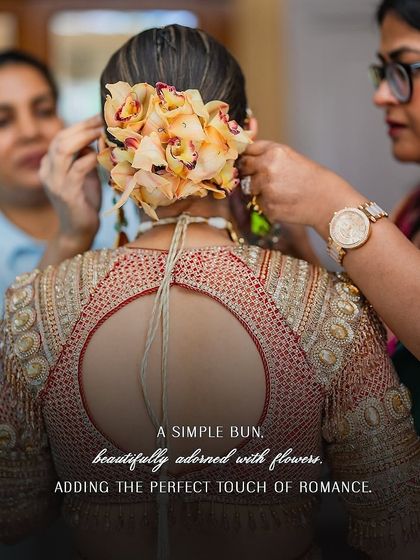 A simple bun, beautifully adorned with flowers, adds the perfect touch of romance to the bride's traditional look. It's all in the details.