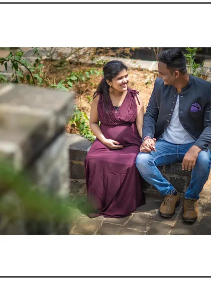 A quiet, seated moment of connection between the expecting parents.