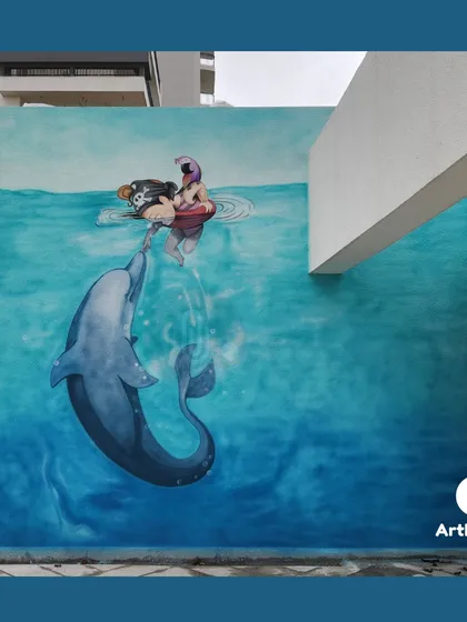 This large-scale outdoor mural in Saan, Gurgaon, creates a stunning visual illusion of a playful dolphin interacting with a swimmer. We love tackling ambitious projects that turn building exteriors into breathtaking works of art.