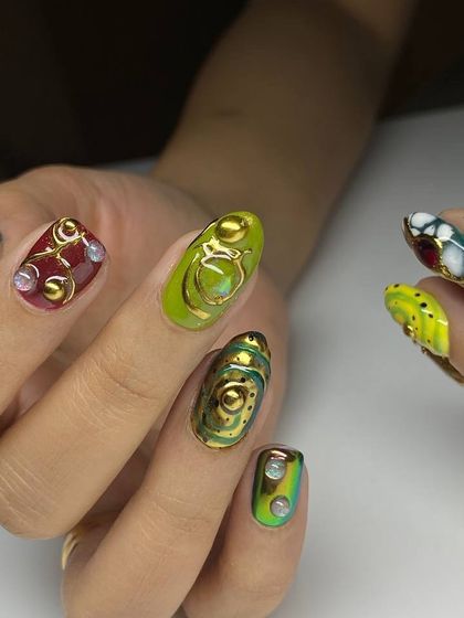 A masterpiece of 3D nail art. This set features an incredible variety of sculpted elements in shades of green, red, and gold, with jewel-like accents and intricate patterns.