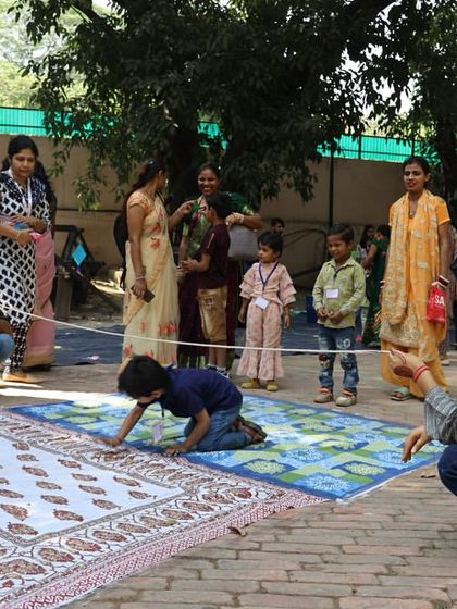 Children participate in a traditional game during the Nanhe Kadam Bal Utsav. Our events are filled with art, culture, and play, celebrating the spirit of childhood.