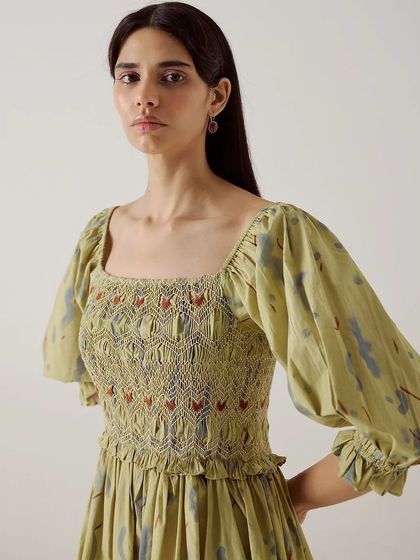 A close-up of the smocked and embroidered bodice of a dress from Cord's Summer '24 collection.