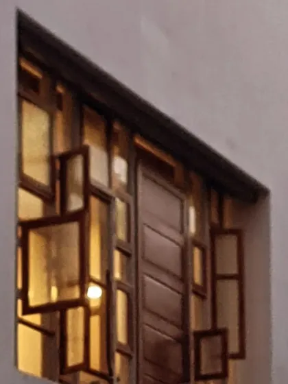 I believe in giving materials a new life. This intricate window at the Kalasangama home was crafted by upcycling and rearranging old doors and windows from the original site, transforming forgotten elements into a new, vibrant facade.